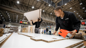 A stand builder assembling a stand at CapeWine 2025